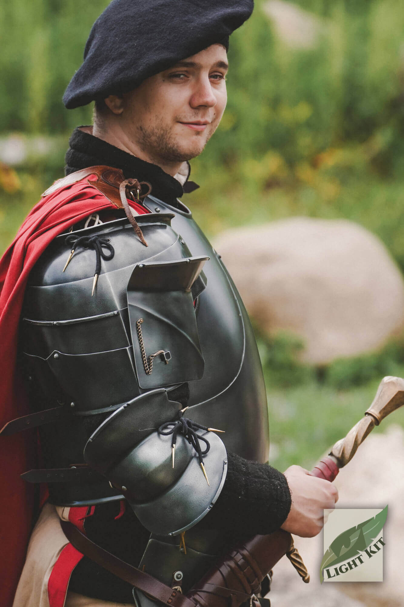 Milanese Complete Set - Light Kit worn by a man in historical armor with a red cape and beret outdoors.