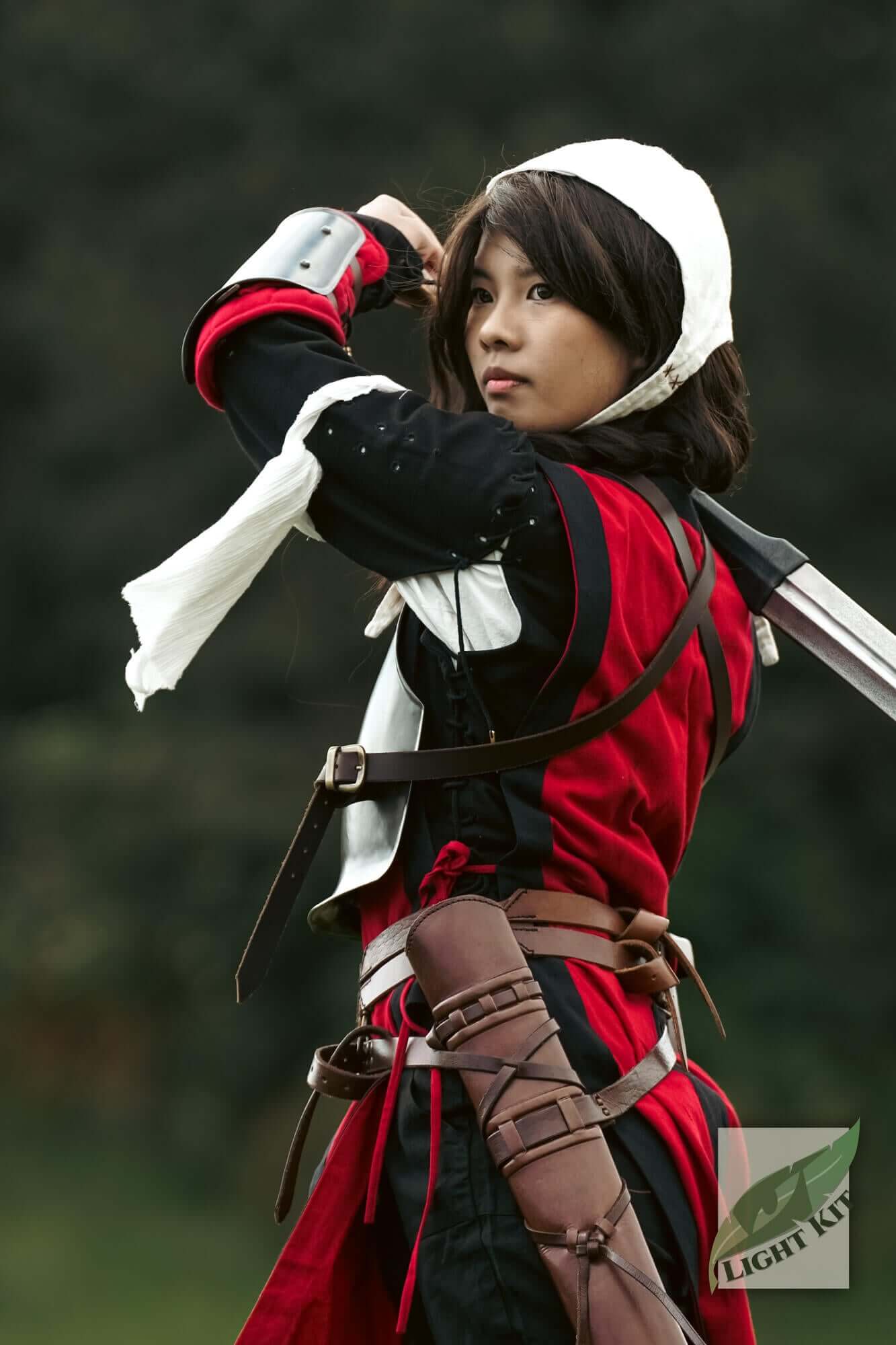 RFB Armour Set - Light Kit worn by a female model showcasing a dynamic pose with sword and red attire.