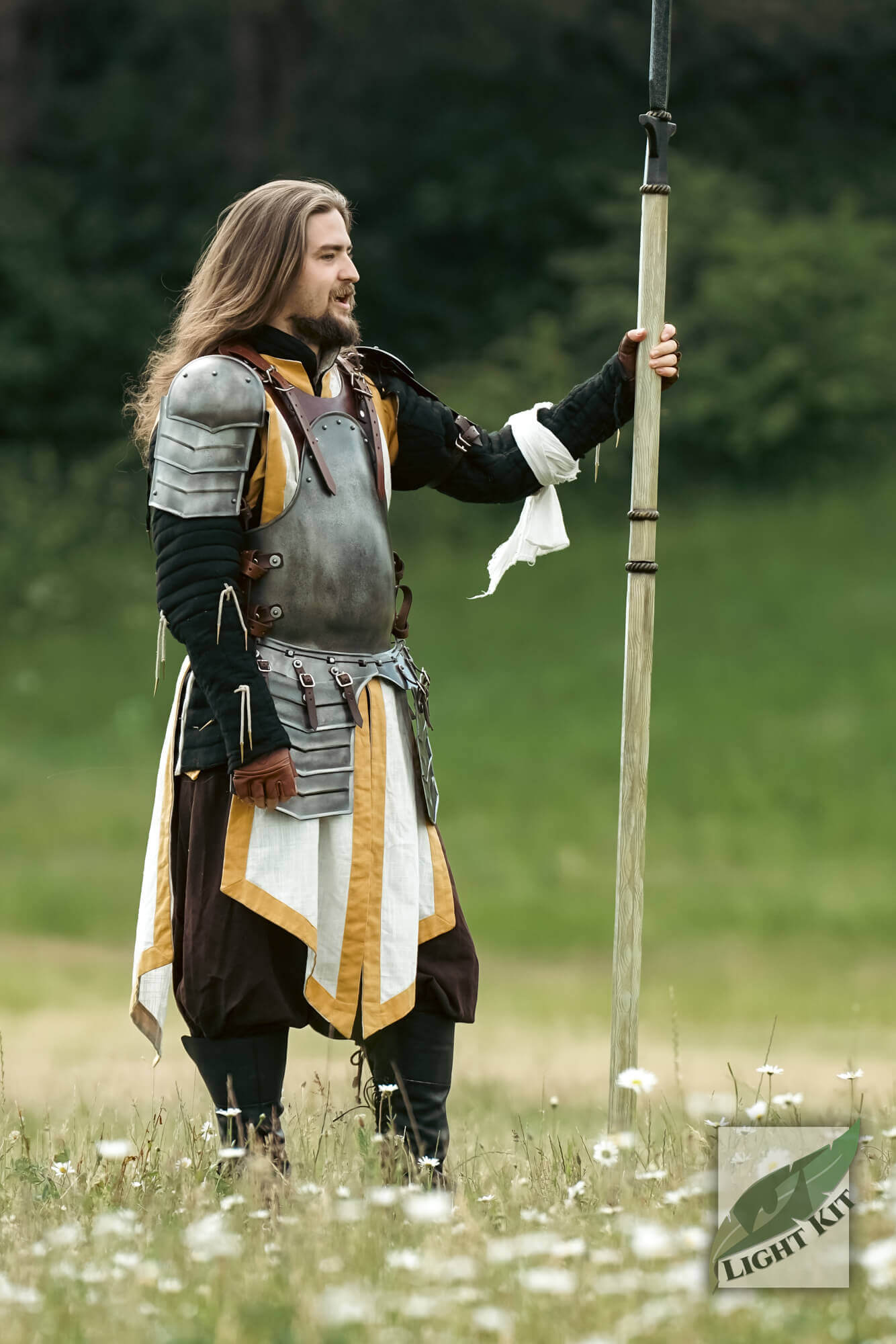 Merc Armour Set - Light Kit worn by a fighter standing in a field with a spear, showcasing rugged mobility and design.