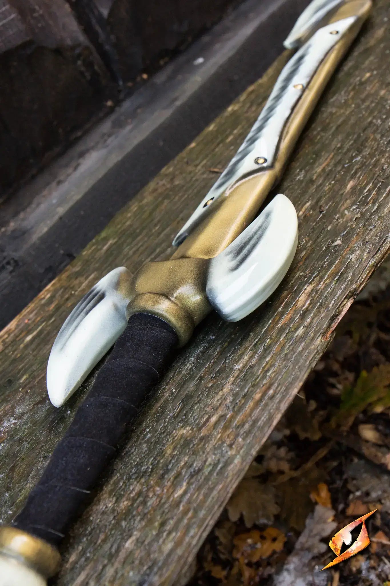 Bone Blade - 95 cm sword with curved single-edged blade and horned crossguard on wooden surface