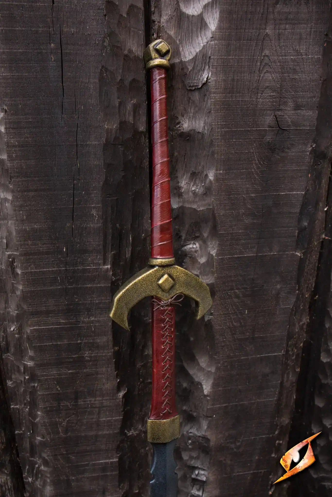 Baal - 140 cm two-handed sword with Celtic design resting against a wooden backdrop.