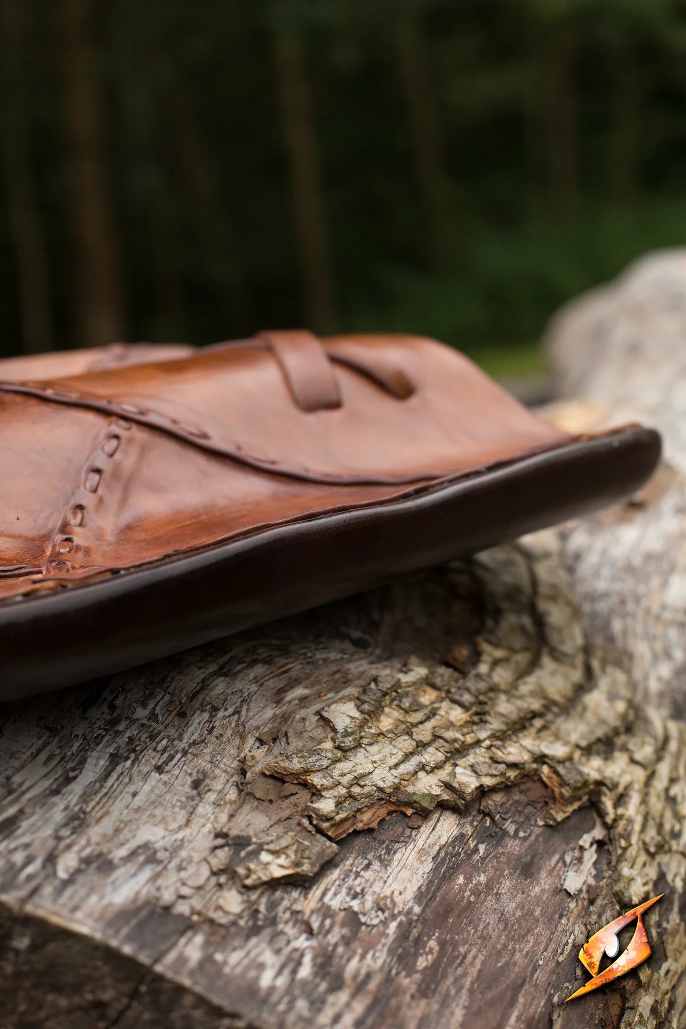 Elven Buckler - 48x28 cm displayed on a wooden surface amidst a forest background.
