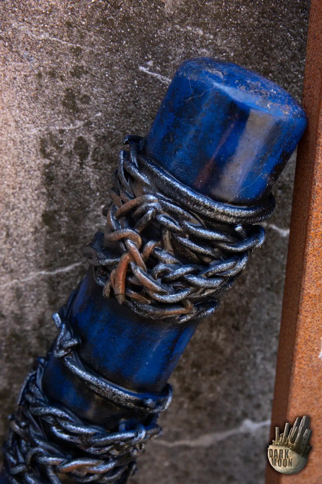 Close-up of Dark Moon's Barbed Wire Bat featuring a blue foam design with barbed wire details.