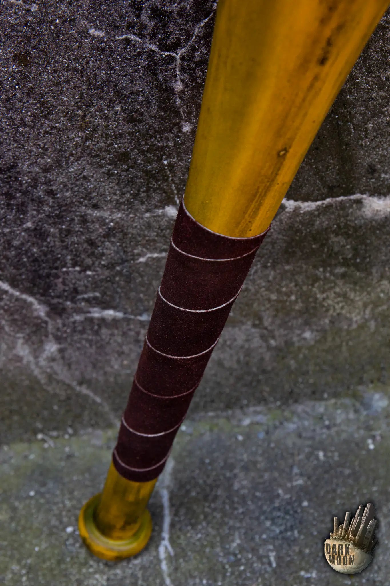 Close-up of Dark Moon's Barbed Wire Bat, featuring a golden finish and dark grip for post-apocalyptic combat.