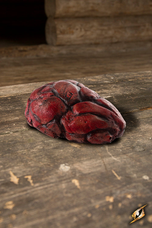 Stone decorative prop depicting a red Bloodstone on a rustic wooden surface.
