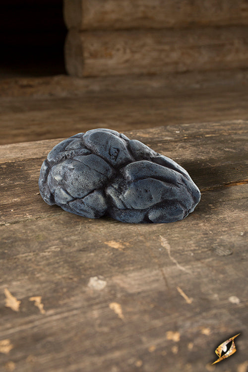 Stone prop on wooden surface, resembling Bloodstone, ideal for enhancing magical spells.