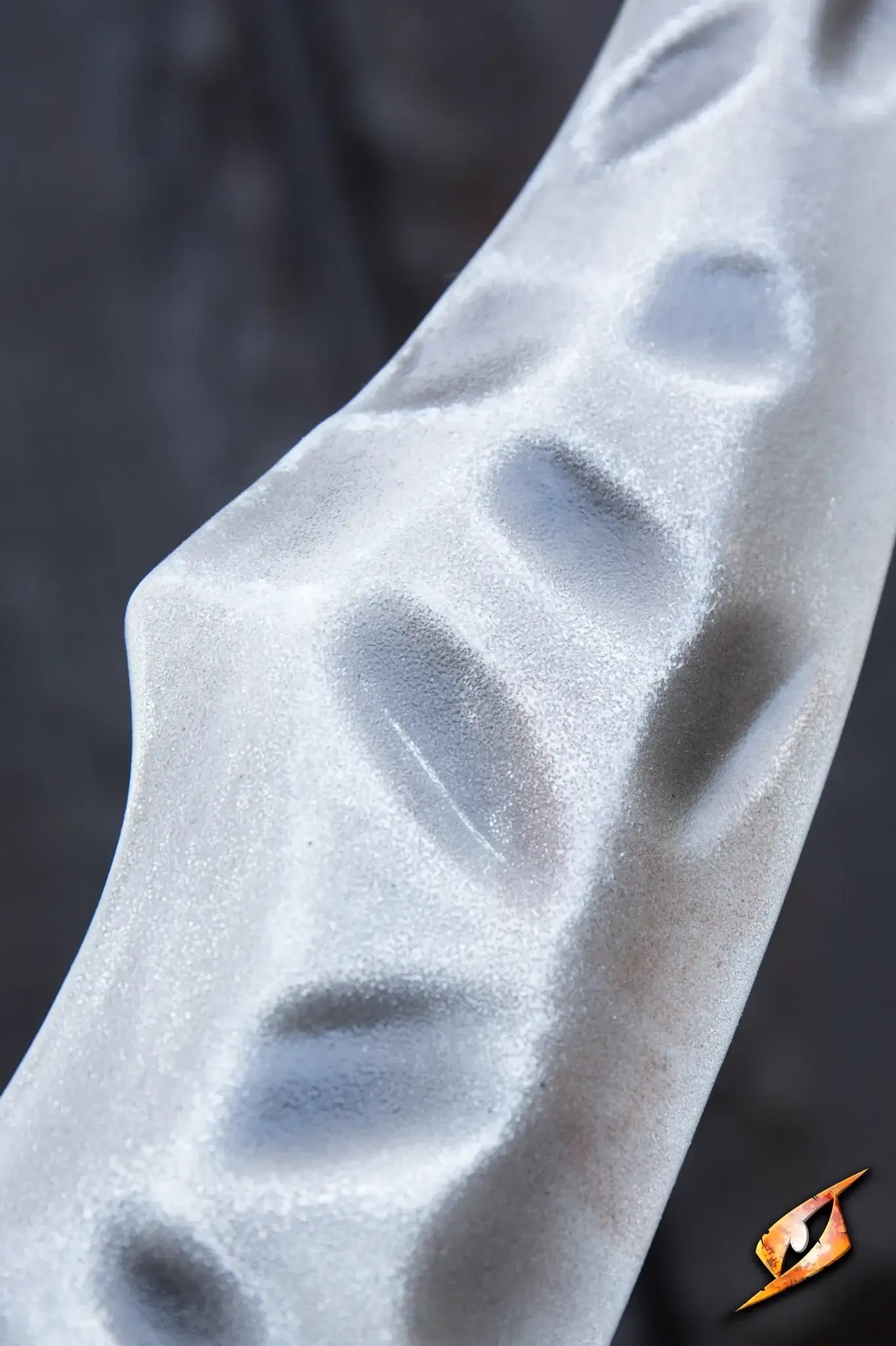 Close-up of the sculpted grip detail on the Bone Scimitar handle, resembling bleached bone texture.