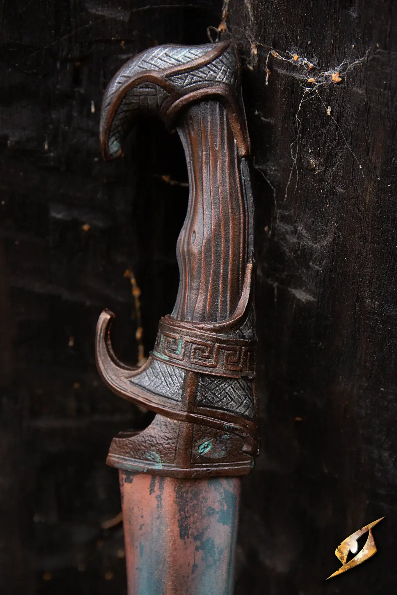 Battleworn Falcata handle detail showcasing intricate design and craftsmanship.