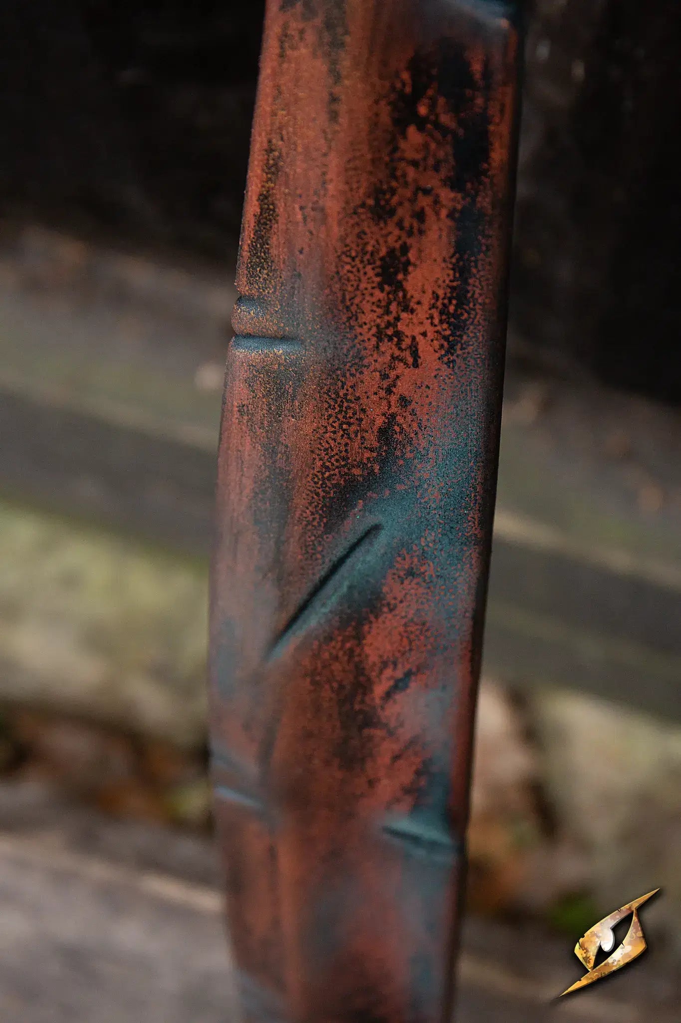 Close-up of the textured blade of the Battleworn Falcata, showcasing its unique hand-painted finish.