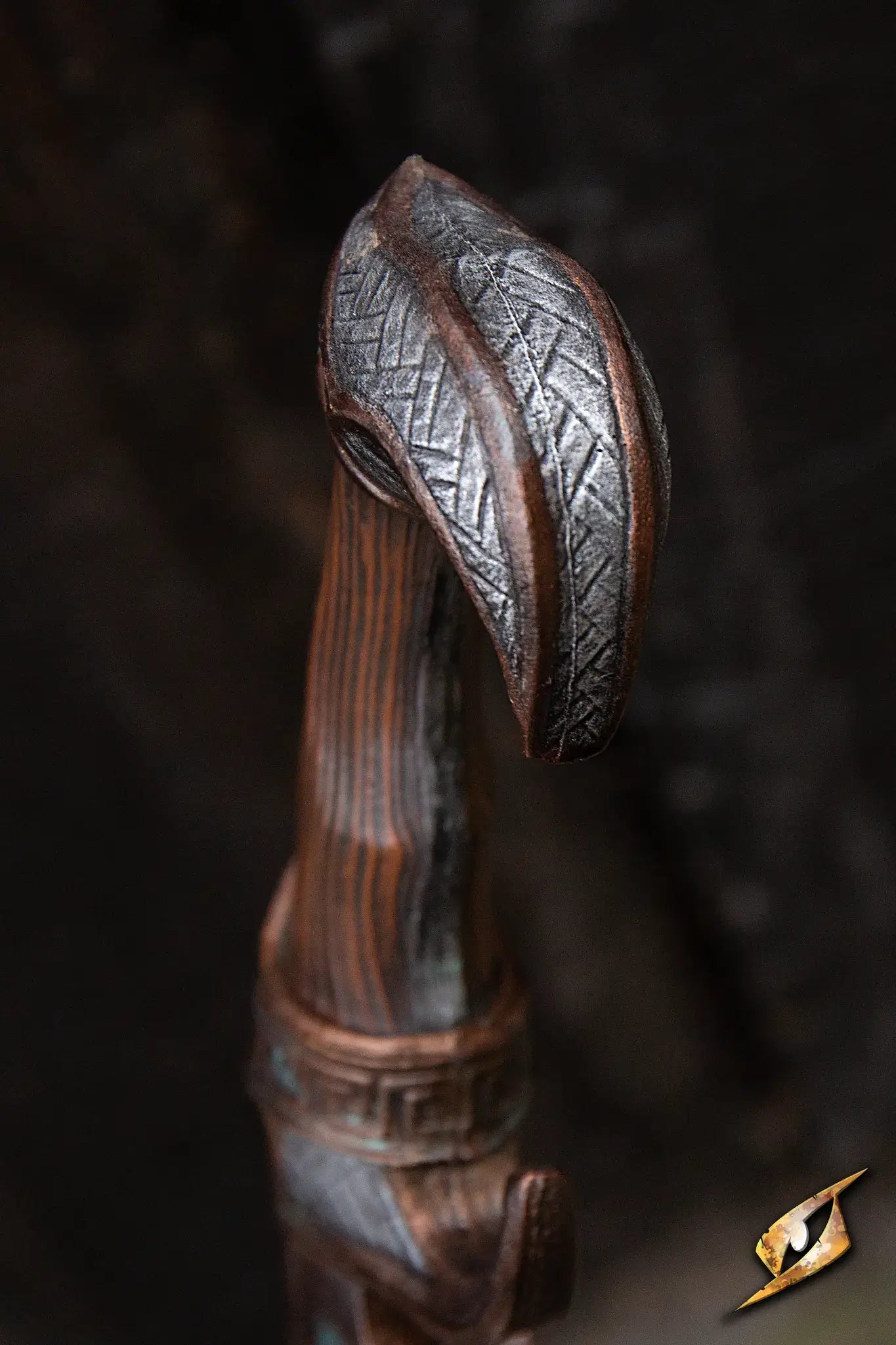 Close-up of the Battleworn Falcata sword's intricately designed hilt and blade tip.