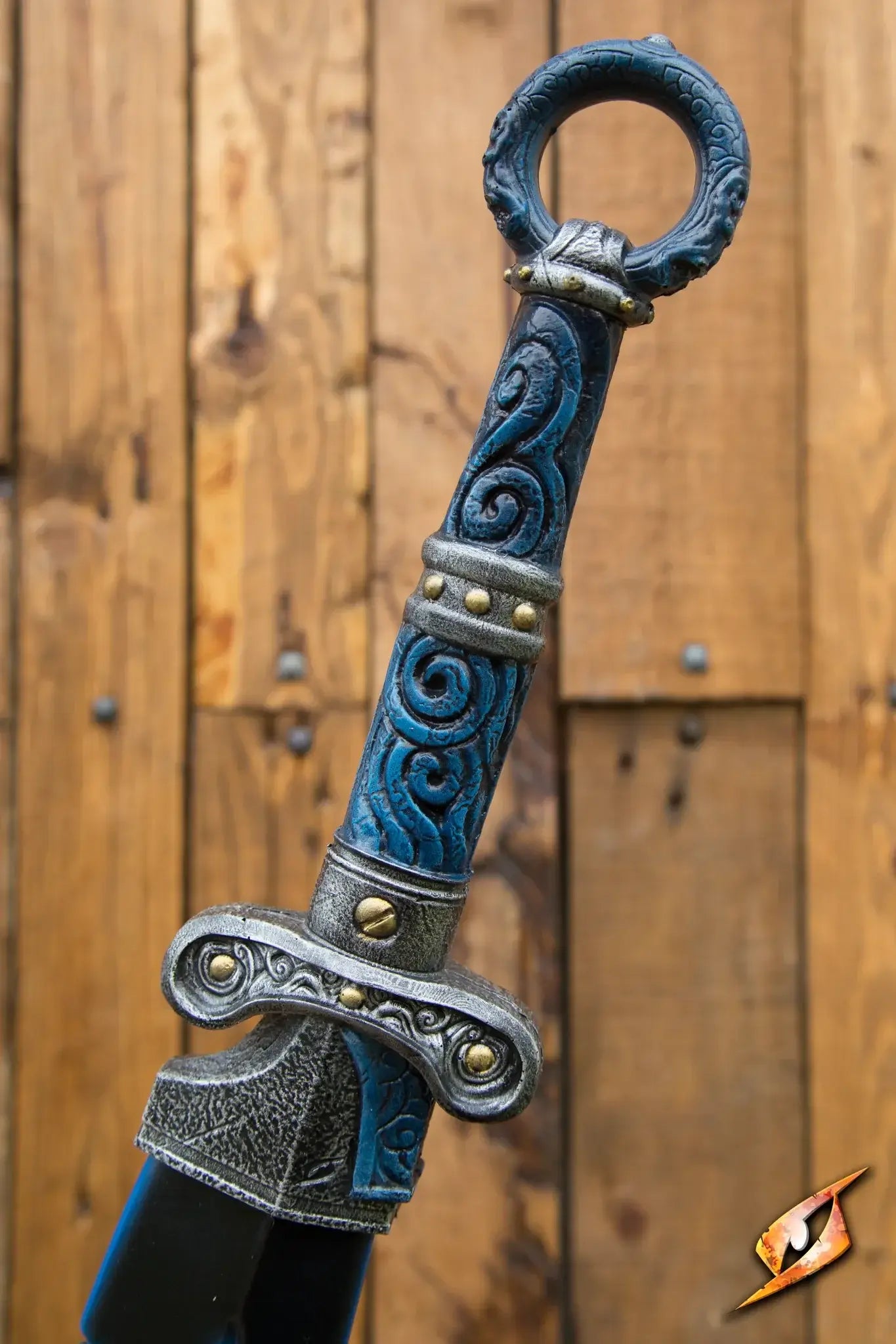A detailed view of the ornate hilt of a sword featuring intricate blue designs and metal accents.