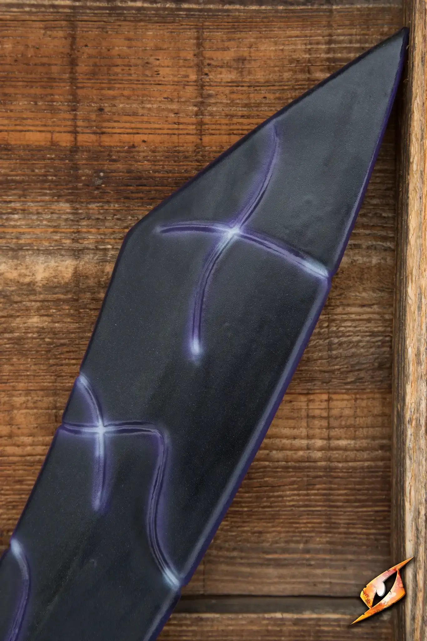 Close-up of the Magic Dao blade featuring intricate purple markings against a dark background.
