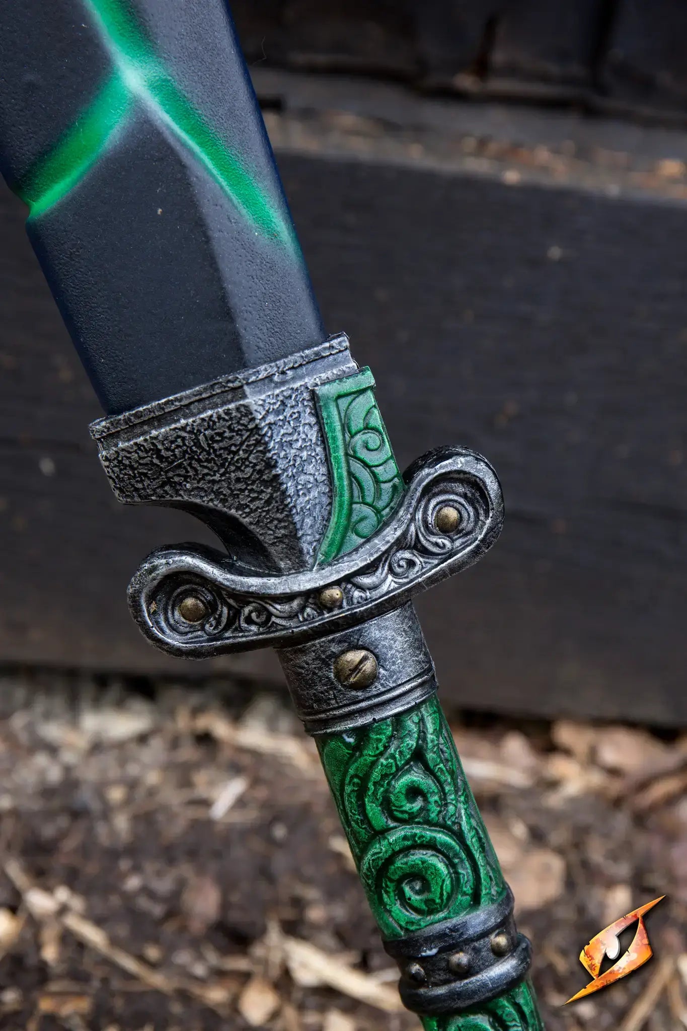 Close-up of the hilt of a sword with intricate green designs and a metallic guard, ideal for the Magic Dao theme.