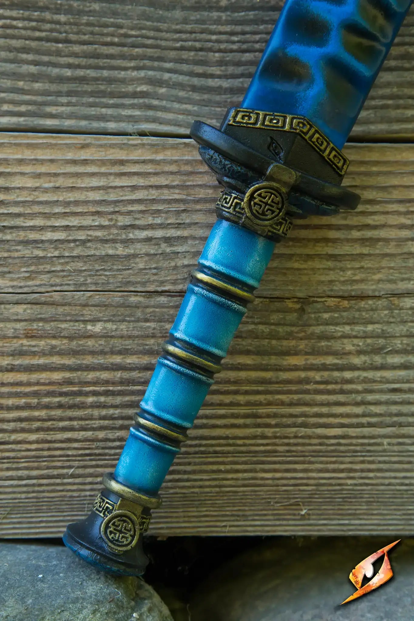 Close-up of the ornate handle of the Magic Jian, showcasing intricate detailing and a vibrant blue color.