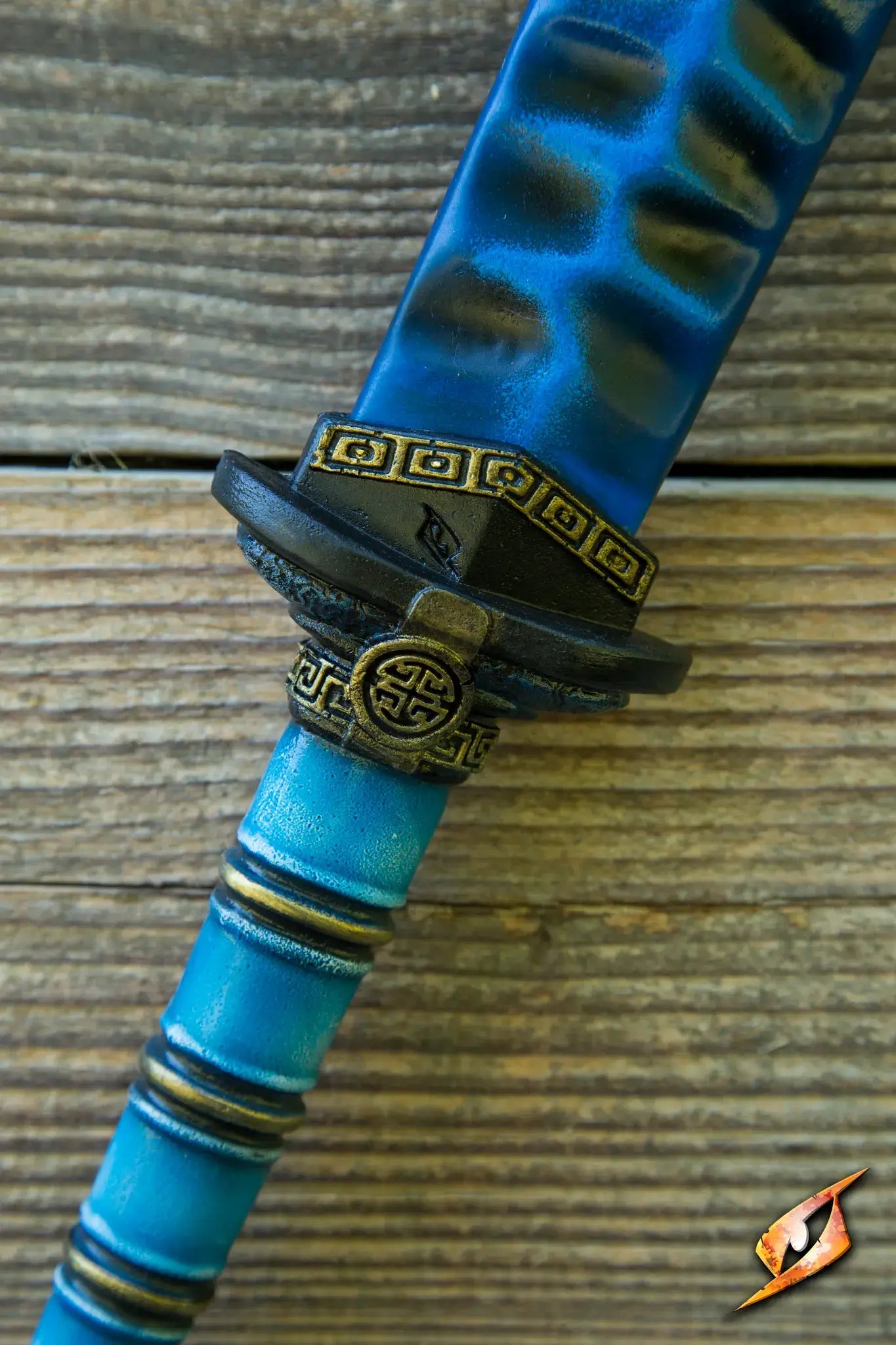 Close-up of the Magic Jian's hilt, showcasing intricate designs and vibrant colors.