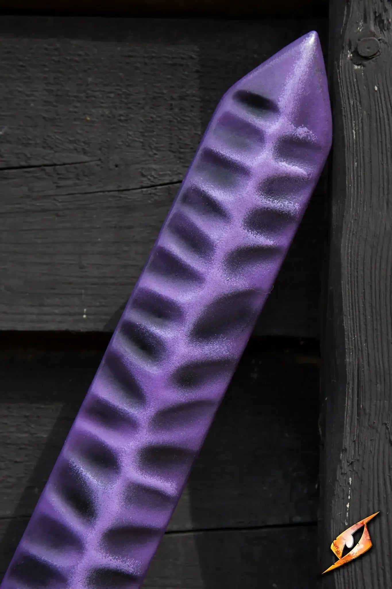Magic Jian with a stunning purple finish resting against a black wooden background.