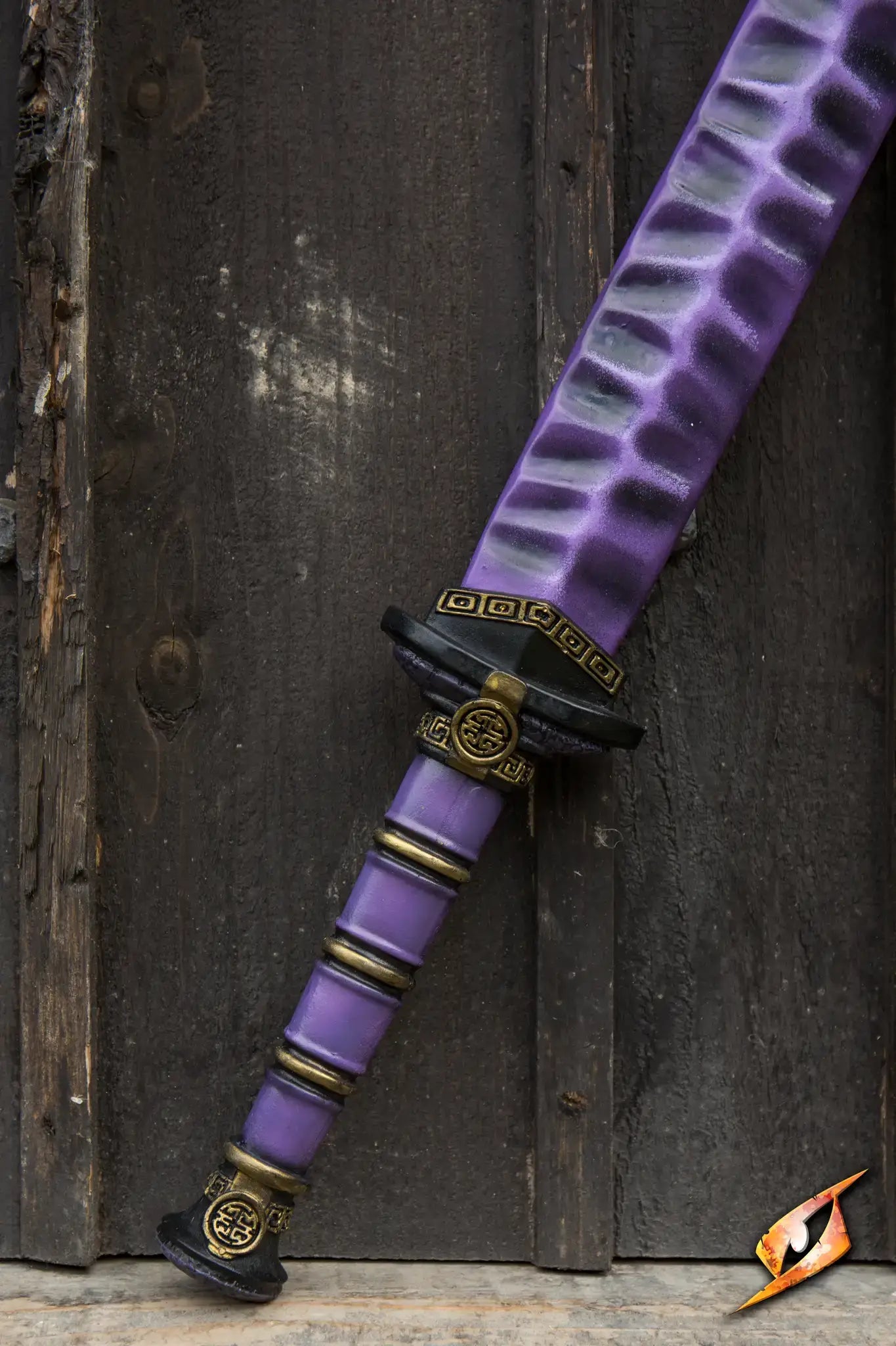 Magic Jian with intricate purple design resting against wooden background.