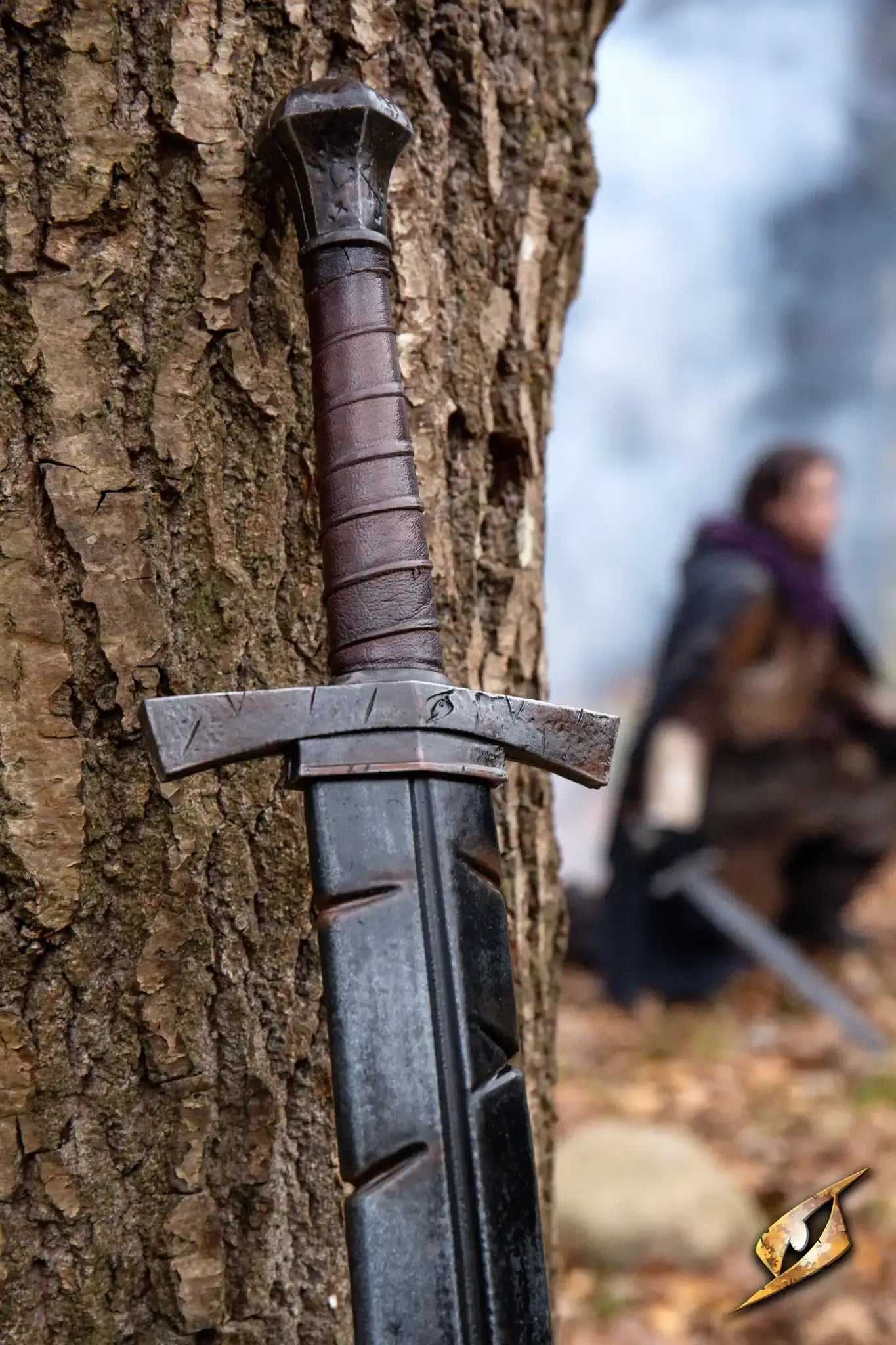 Battleworn Footman Sword resting against a tree, showcasing its realistic weathered details.