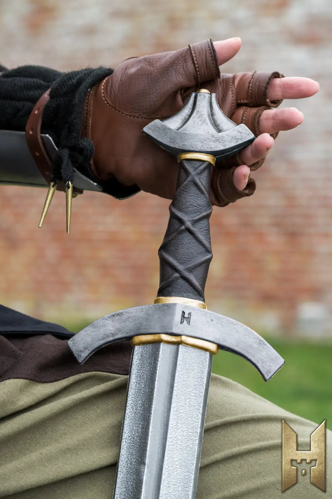 Details of the Stronghold Arming Sword in a wielder's hand, ideal for LARP and cosplay.