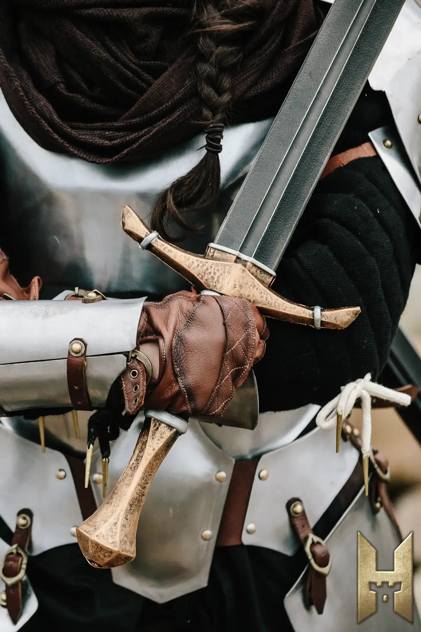 Bastard Sword being held by a warrior in armor, showcasing its detailed craftsmanship and robust design.