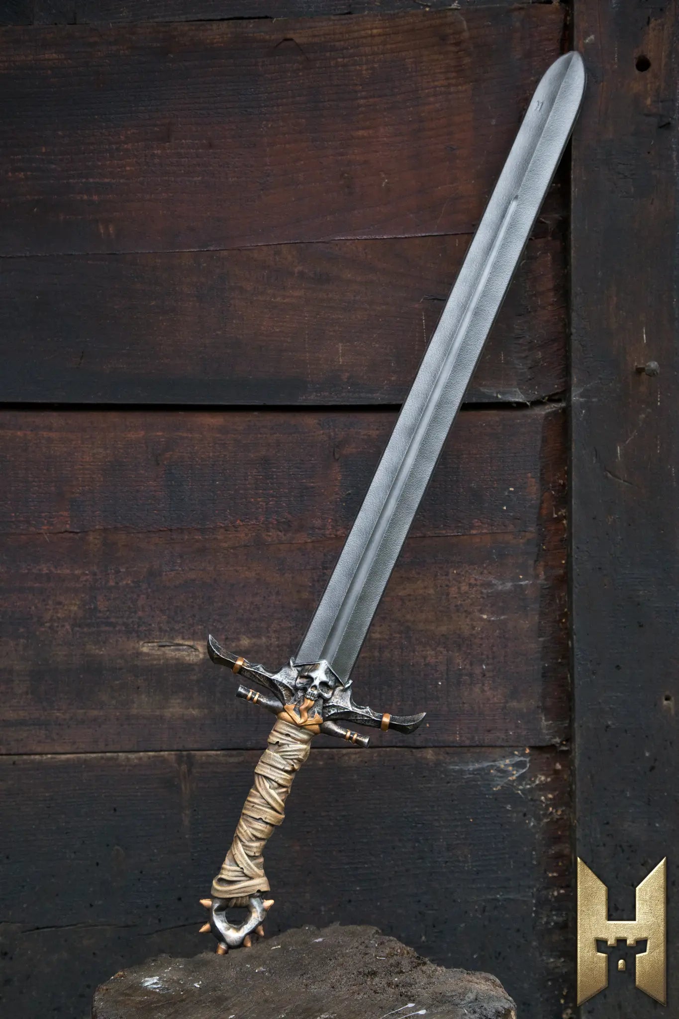 Marauder Sword displayed against a rustic wooden background, featuring a detailed hilt and long shiny blade.