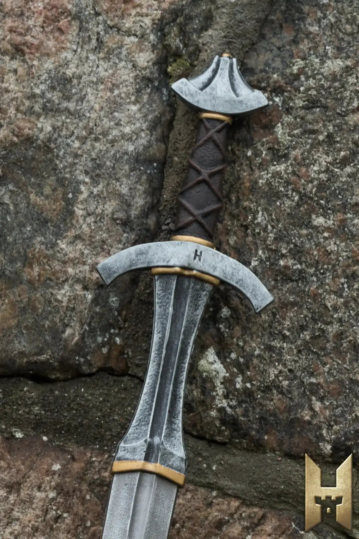 Arming Sword resting against a stone wall, showcasing its intricate design and craftsmanship for LARP and cosplay.