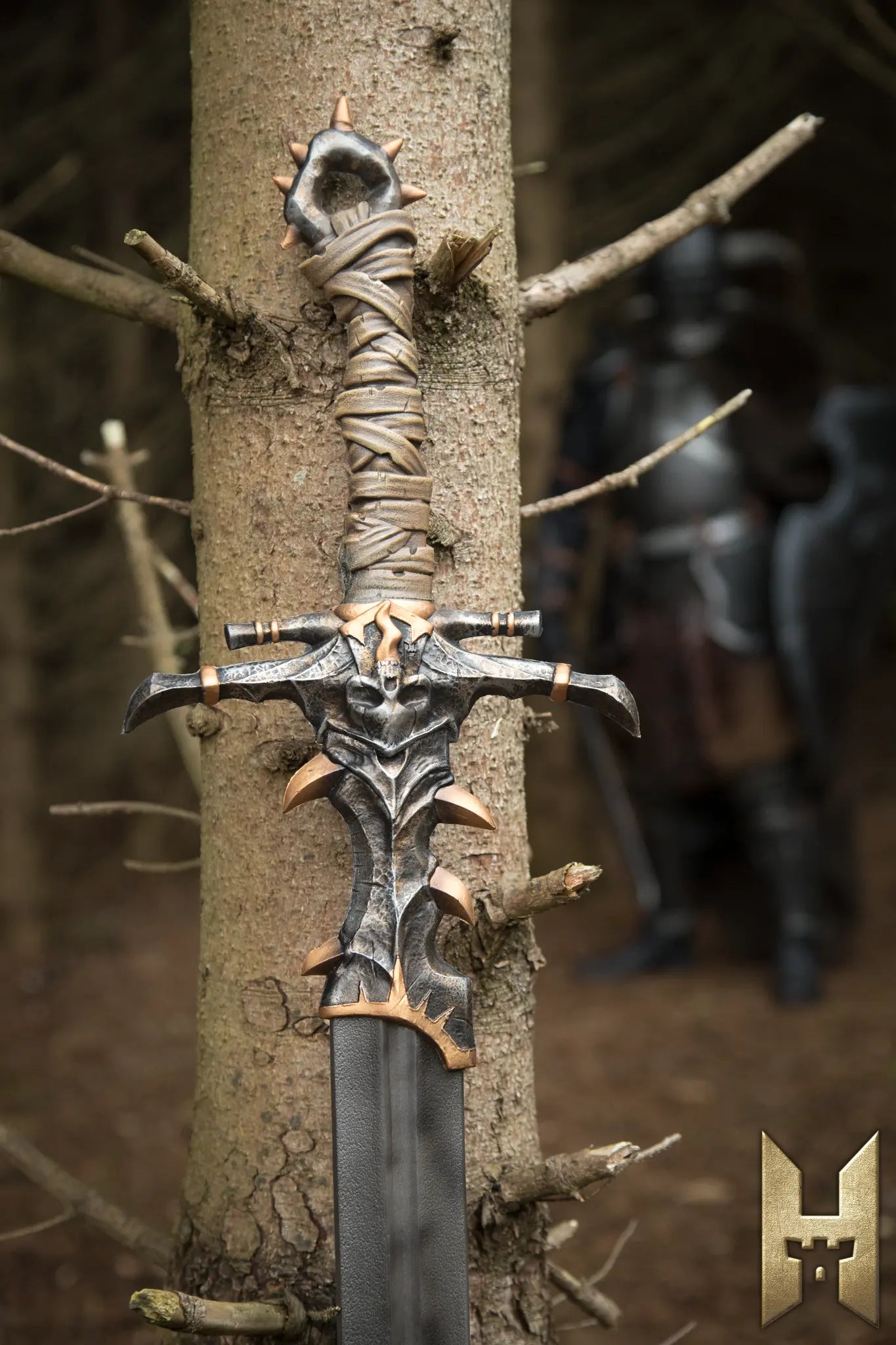 Marauder Sword with intricate design displayed against a tree in a forest setting.