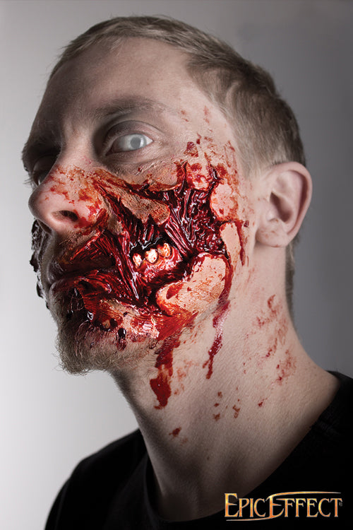 Close-up of a man's face with gruesome Zombie Cheek Torn makeup, showcasing gory details and a haunting expression.
