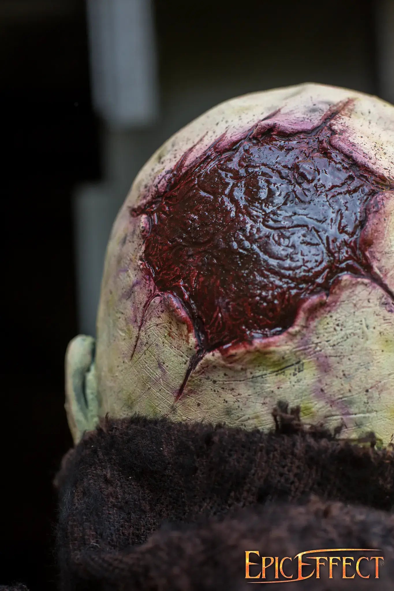 Scarface Zombie prosthetic effects showcasing a gruesome wound on the scalp, evoking a horror theme.