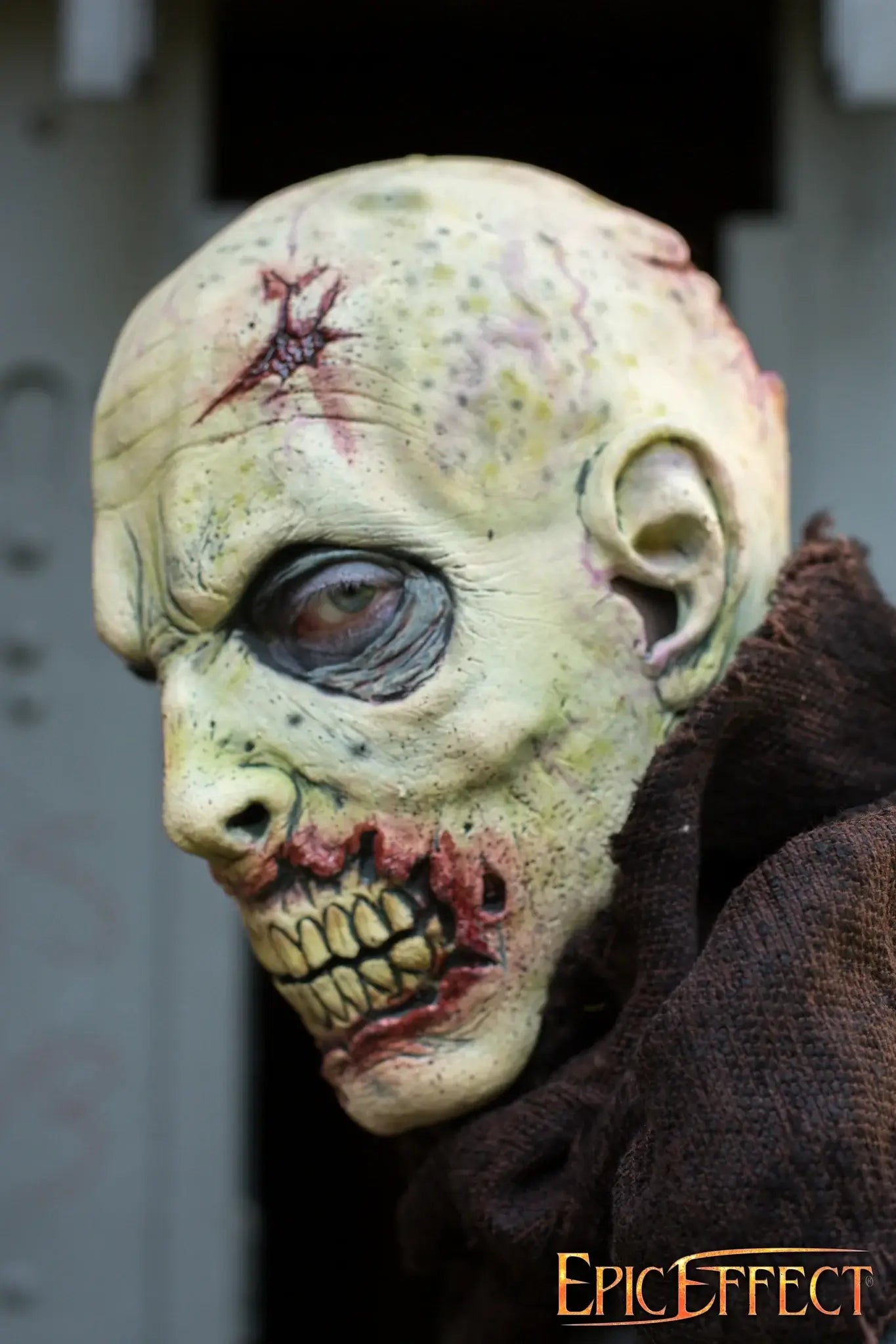 Scarface Zombie wearing a tattered robe, showcasing grotesque details of decay and hunger.