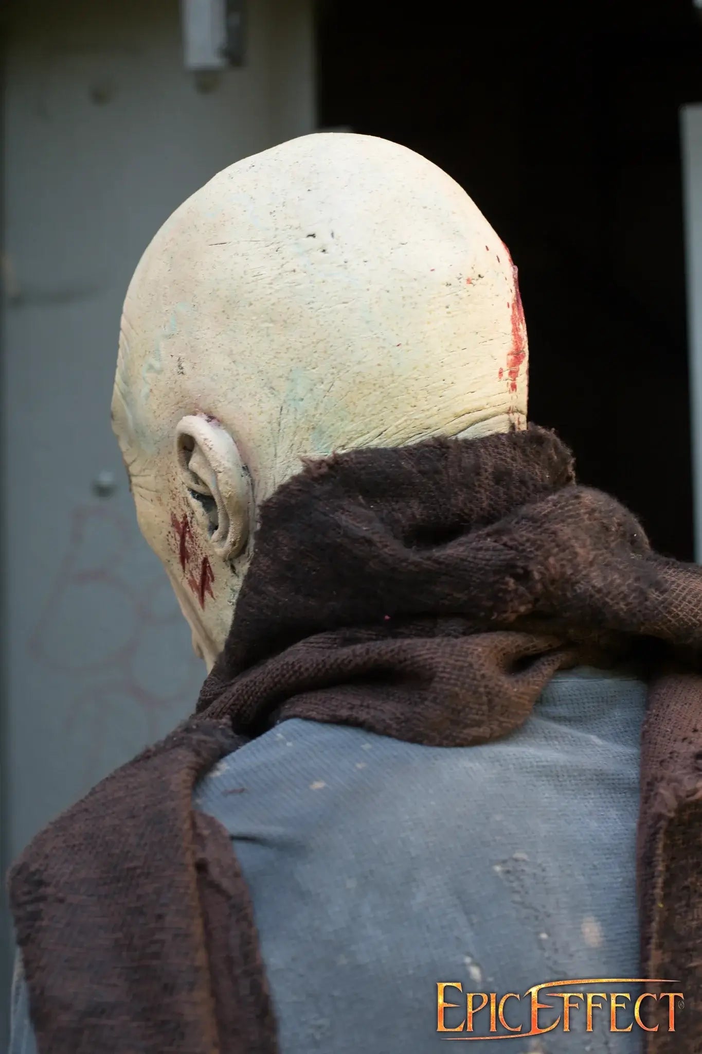 Half Face Zombie doll with details showcasing a worn head and tattered scarf, emphasizing the eerie undead essence.