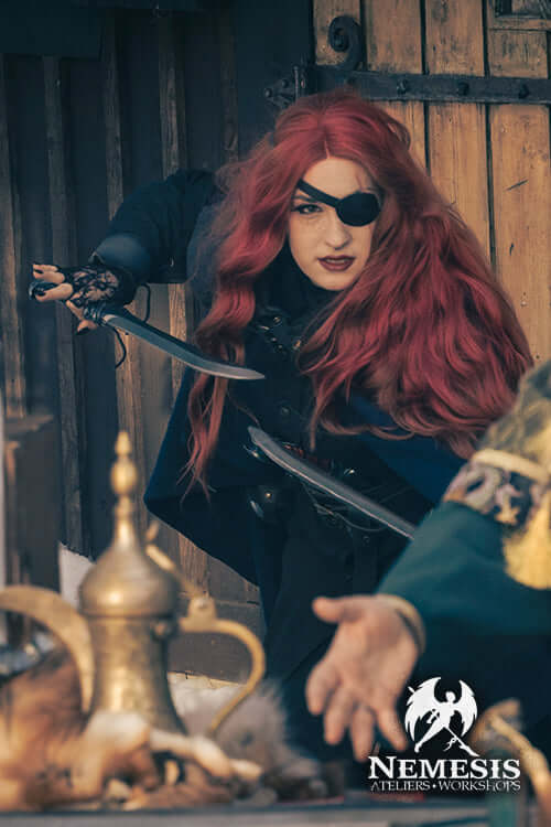 A fierce character wielding an Assassin's knife in an action-ready pose, dressed in dark attire with red hair.
