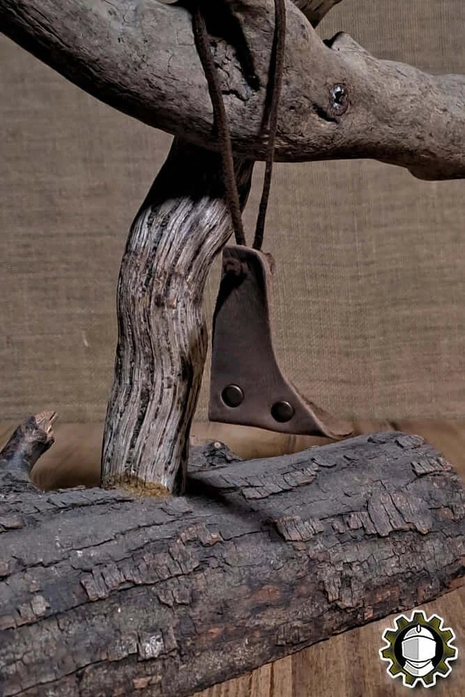Blade Hook (New Blood) attached to a rustic wooden support, showcasing its leather design and functionality.