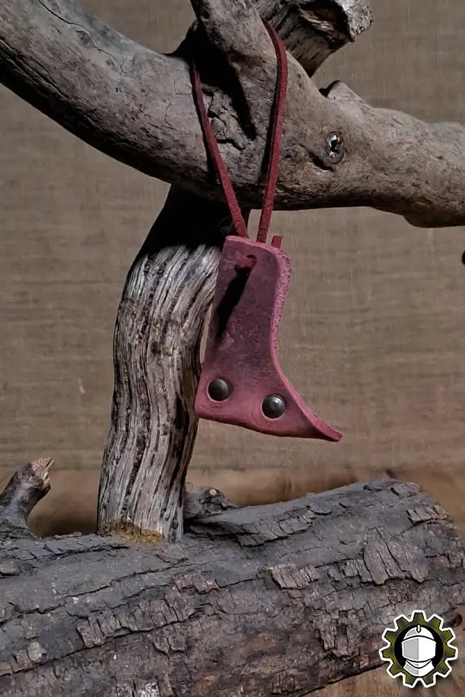 Blade Hook (New Blood) hanging from a tree branch, showcasing its elegant design and functionality for securing weapons.