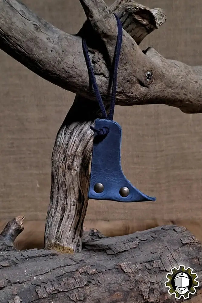 Blade Hook (New Blood) in blue leather, designed for securing crossguard-less weapons, showcased on natural wood.