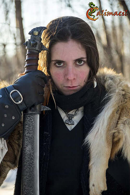 Person holding the Baen Si II sword, showcasing its unique design and rugged appearance.