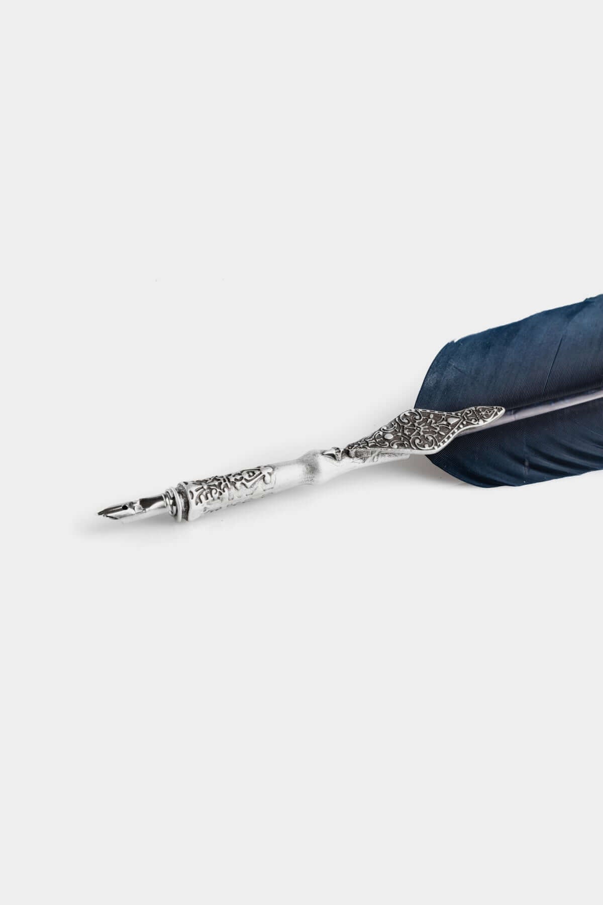 Calligraphic Writing Set featuring a metal-adorned feather pen with a silver holder.