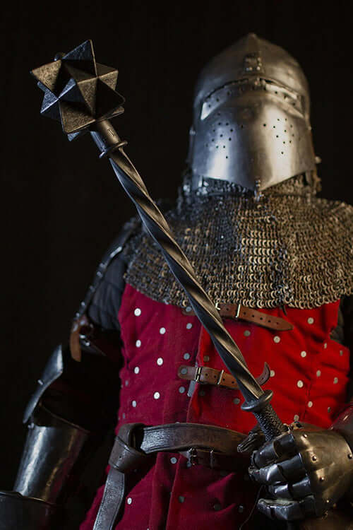 Bailiff's Mace held by a knight in armor, showcasing the replica mace from Kingdom Come: Deliverance.