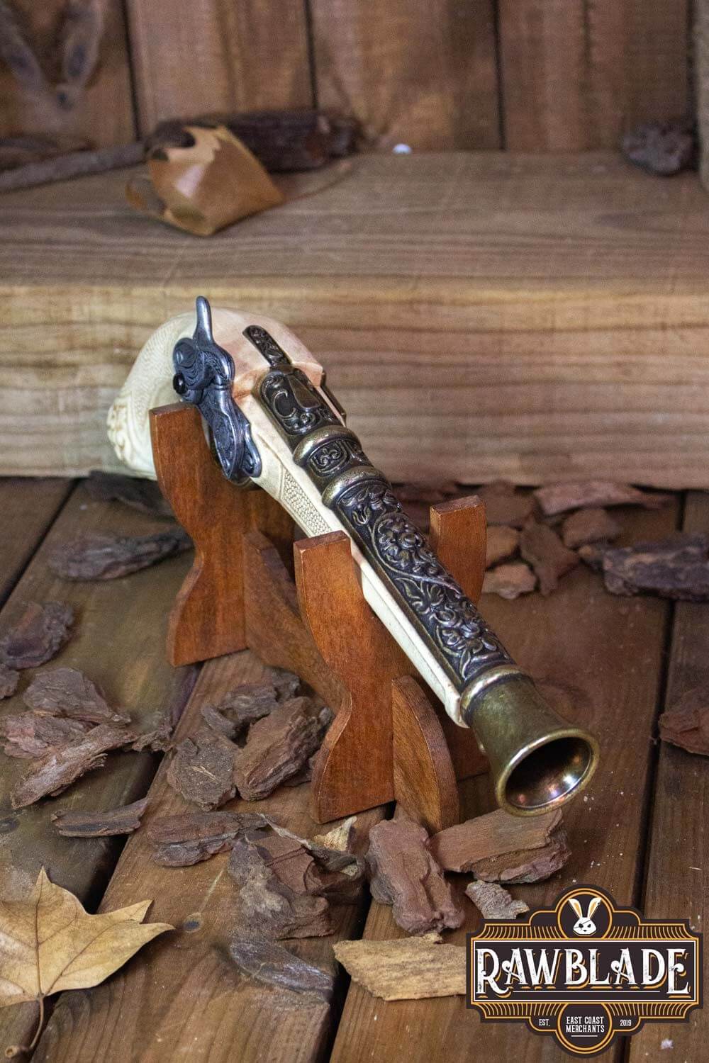 Thunder Gun displayed on wooden stand surrounded by autumn leaves, showcasing its detailed design and craftsmanship.