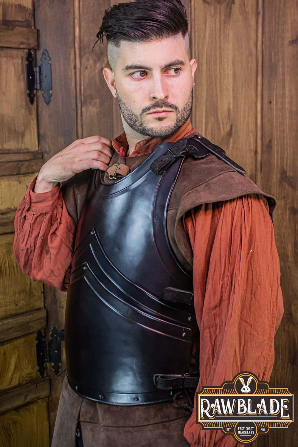 Man wearing Alonso Cuirass armor showcasing its layered iron and leather strap design.