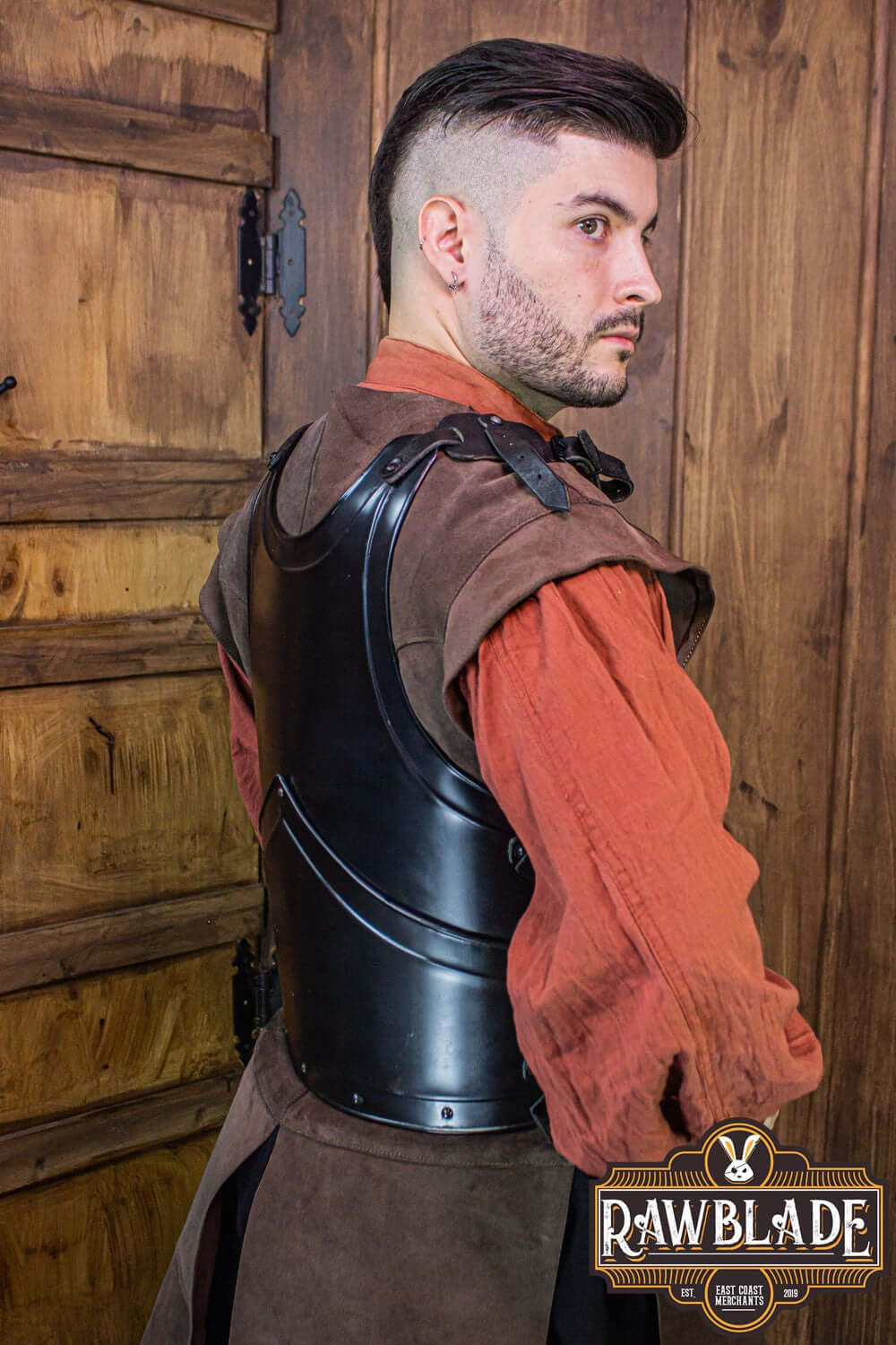 Man wearing Alonso Cuirass armor piece showcasing layered iron and leather straps.