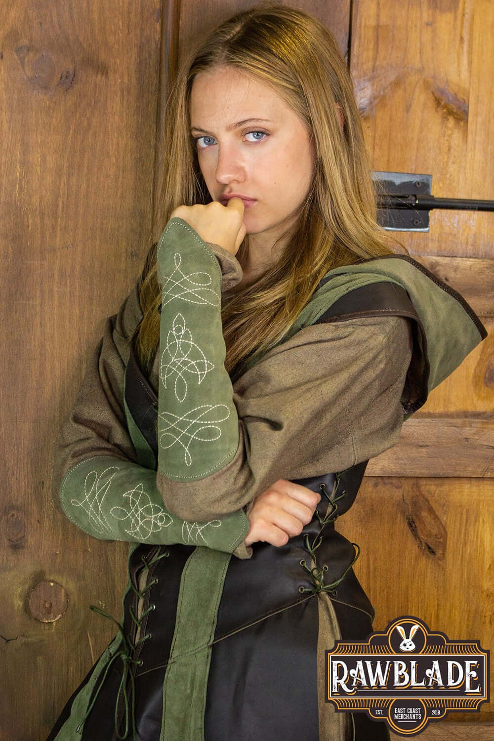 Woman wearing Arylith Archer Leather Tunic with a stylish hood and embroidered sleeves from Rawblade.