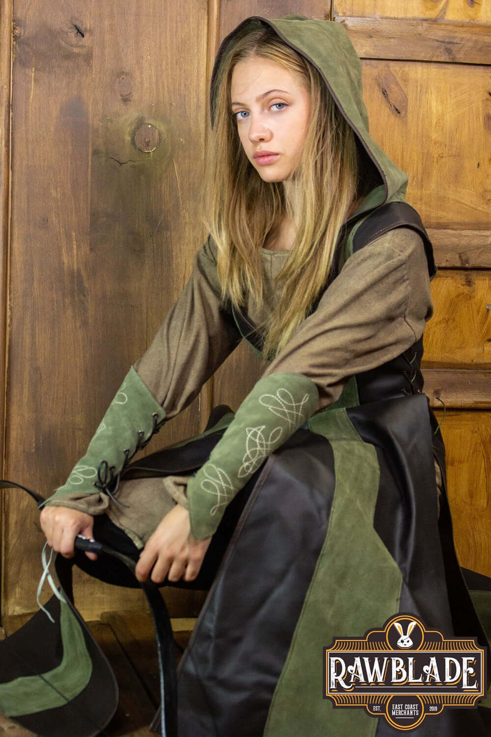 Arylith Archer Leather Tunic model showcasing its elegant design and fitted cut with a wide hood.