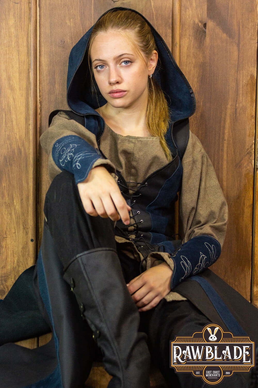 Arylith Archer Leather Tunic model wearing an elegant fitted design with hood and drawstrings, showcased by Rawblade.