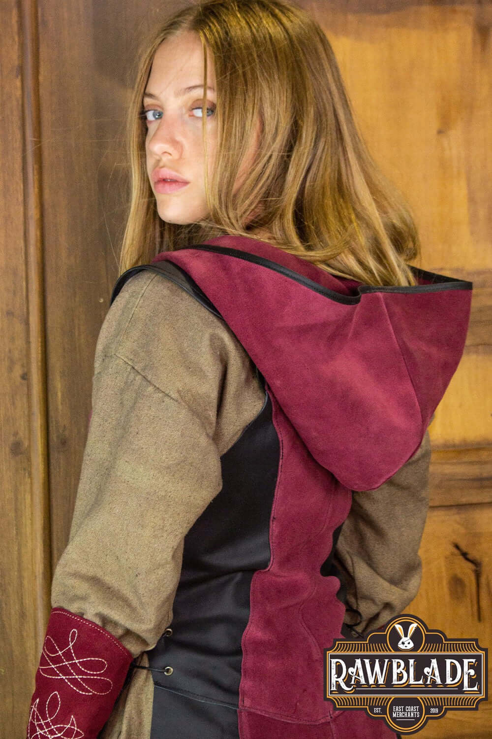 Arylith Archer Leather Tunic featuring a stylish hood and elegant design, shown on a model with long hair.
