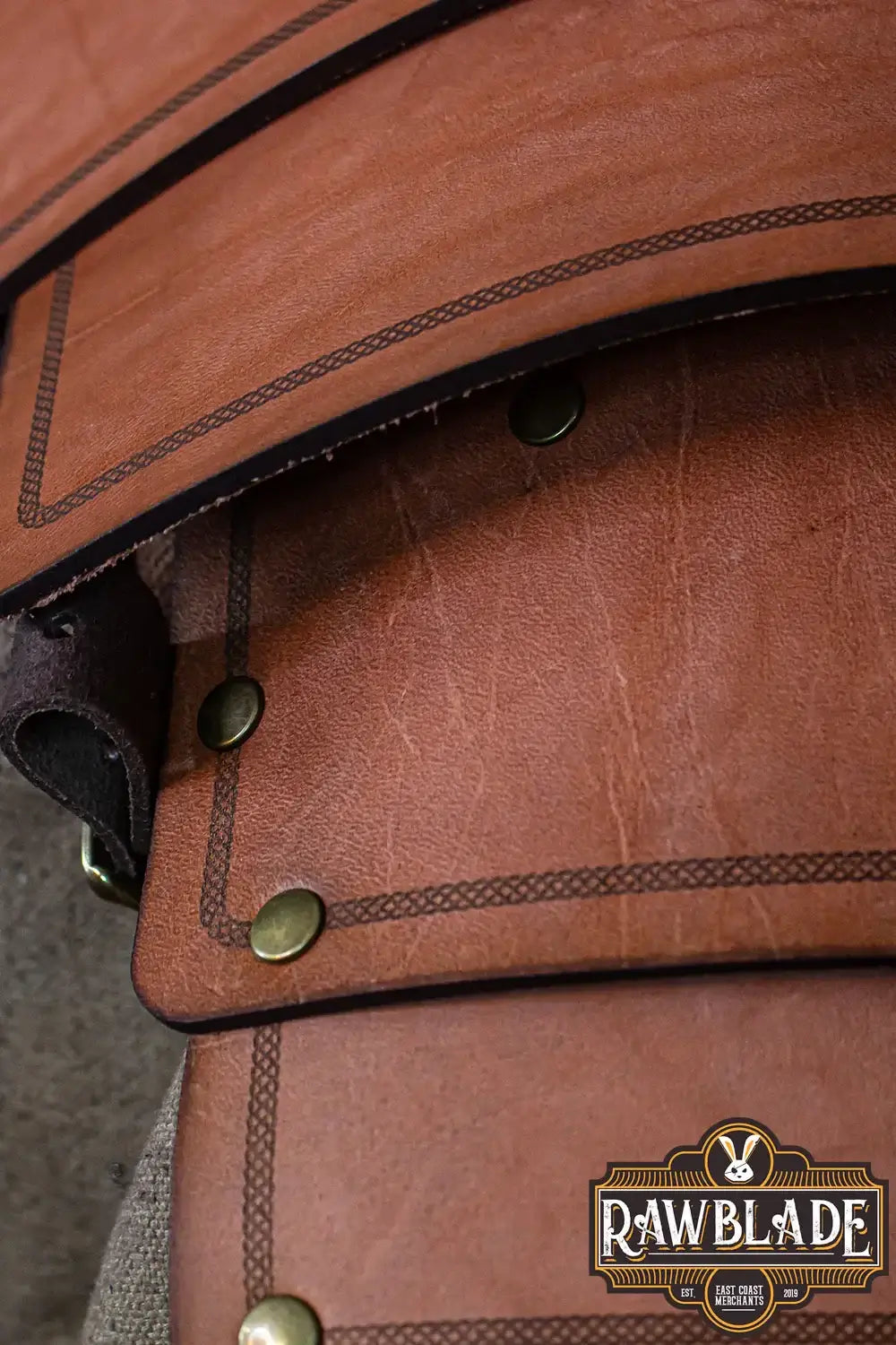 Detailed view of the Adventurer Shoulder pad showcasing aged leather and brass studs for an authentic adventurer look.