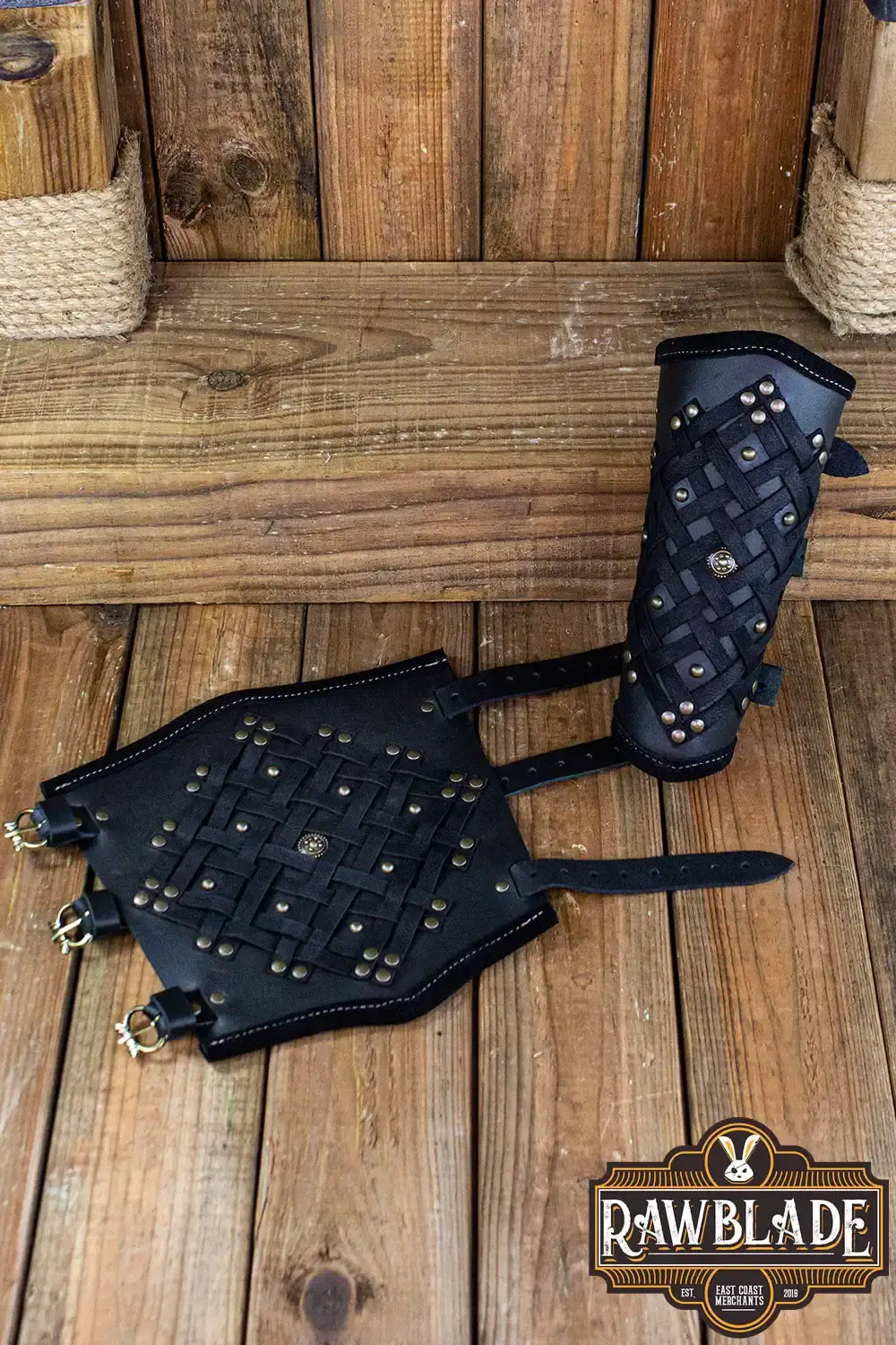 Brawley Studded Bracelets displayed on wooden backdrop, featuring leather with studs and intricate stitching.