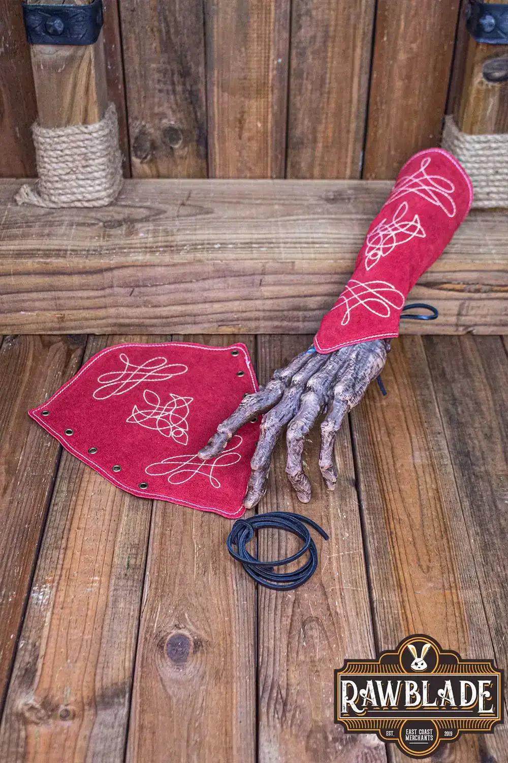 Vryla Premium Bracers displayed on a wooden surface, showcasing elven style leather craftsmanship.