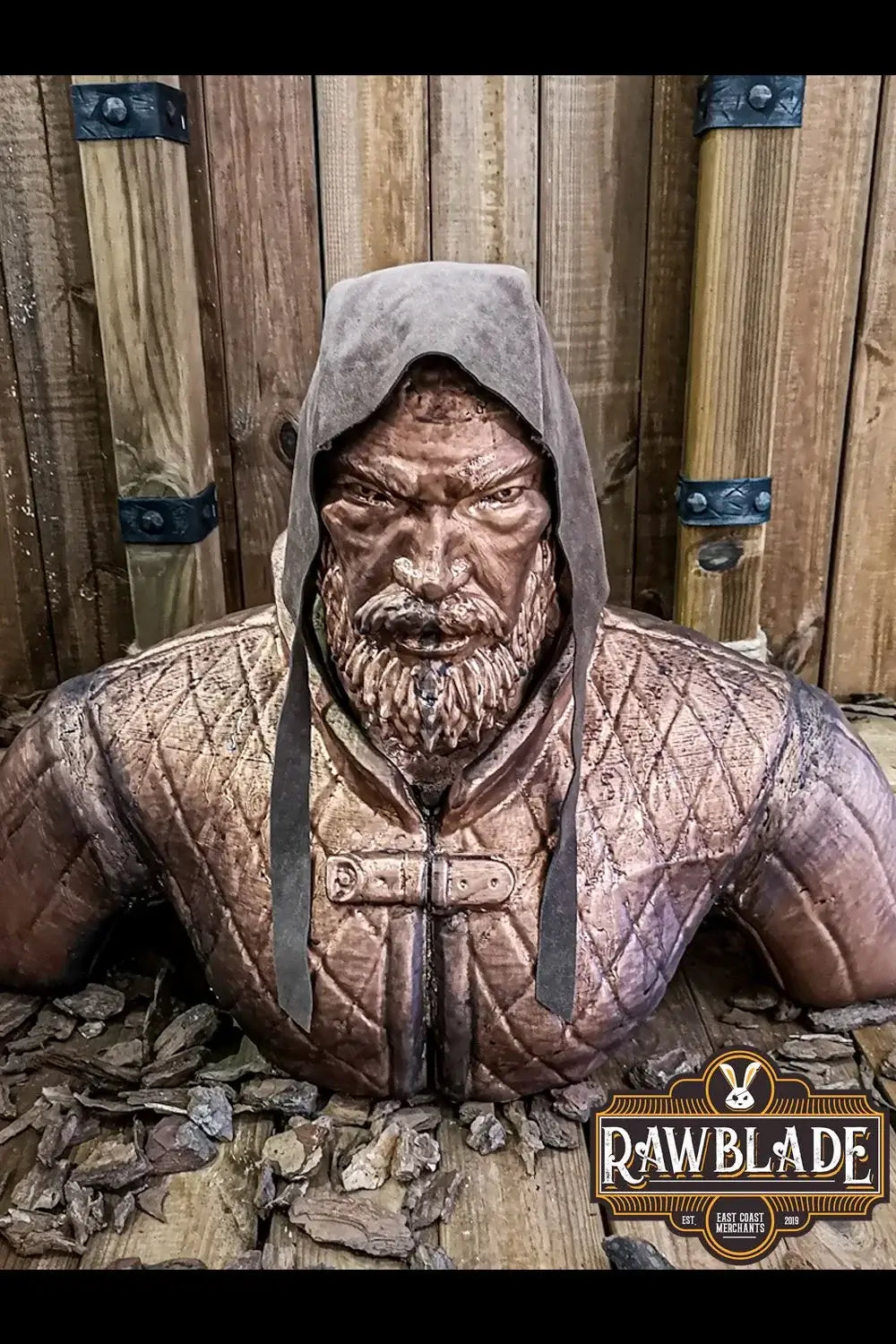 Rawblade Barbadok Leather Coif displayed on a statue with a fierce expression and a hood.