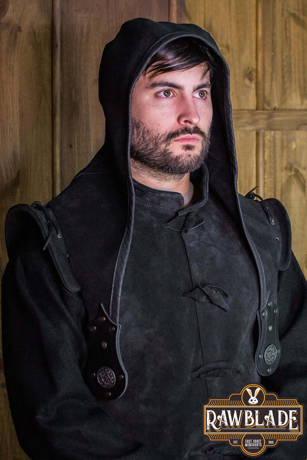 Man wearing Akku Splitleather Hood, featuring leather reinforcements and metal ornaments.